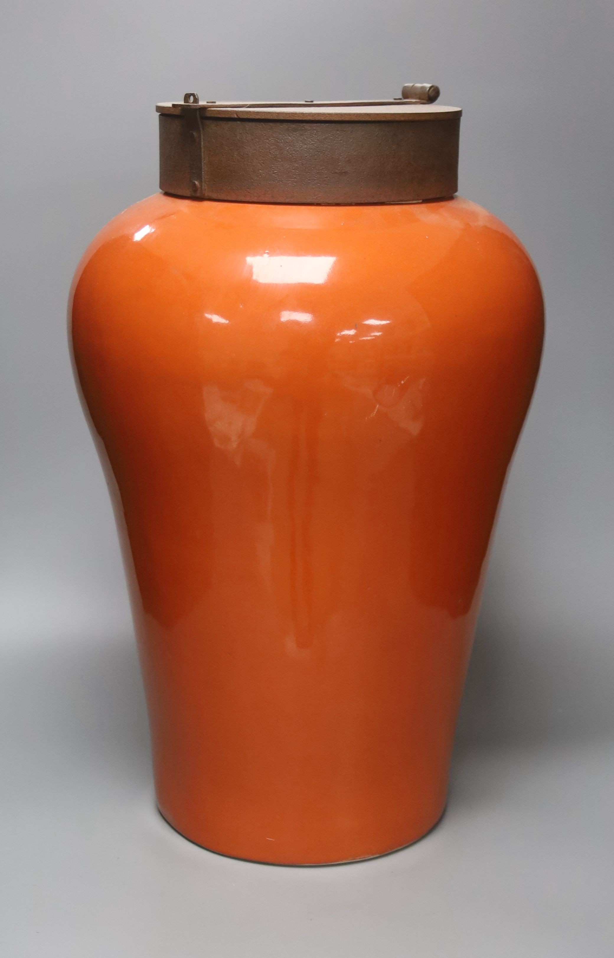 A large orange porcelain vase of shouldered form with applied iron cap 52cm